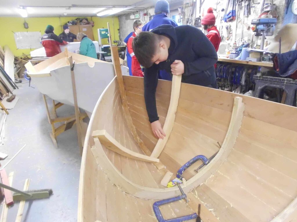 Image of Banff Academy pupils in the boat building workshop at Cullen Sea School