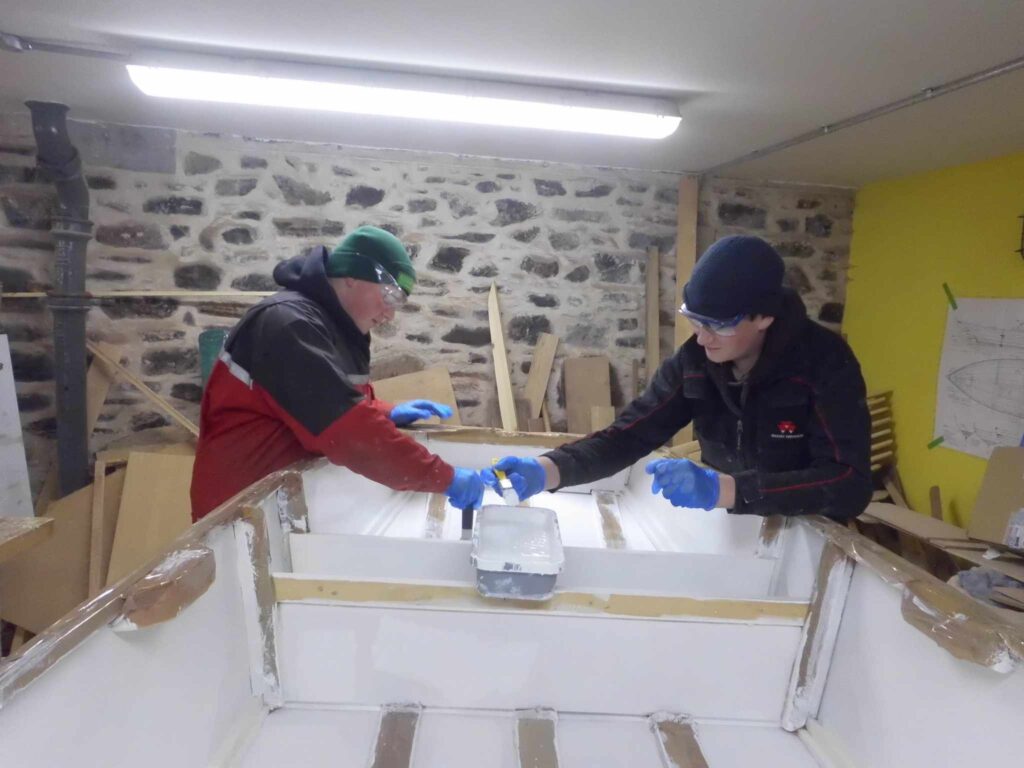 Image of Banff Academy pupils in the boat building workshop at Cullen Sea School