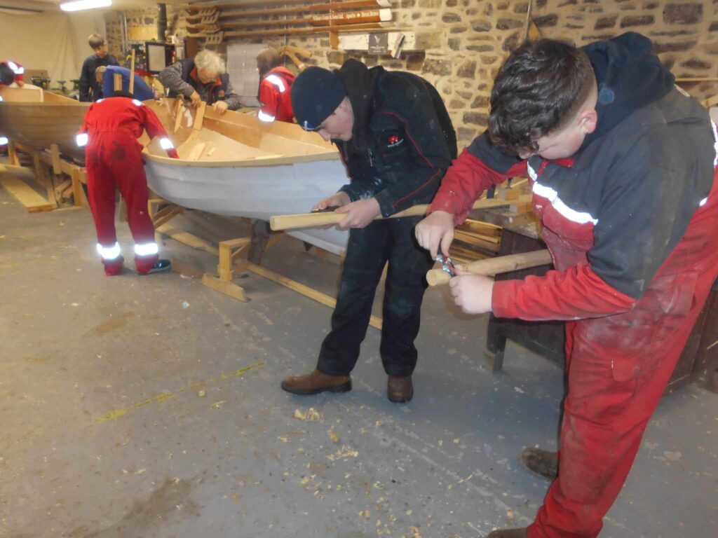 Image of Banff Academy pupils in the boat building workshop at Cullen Sea School