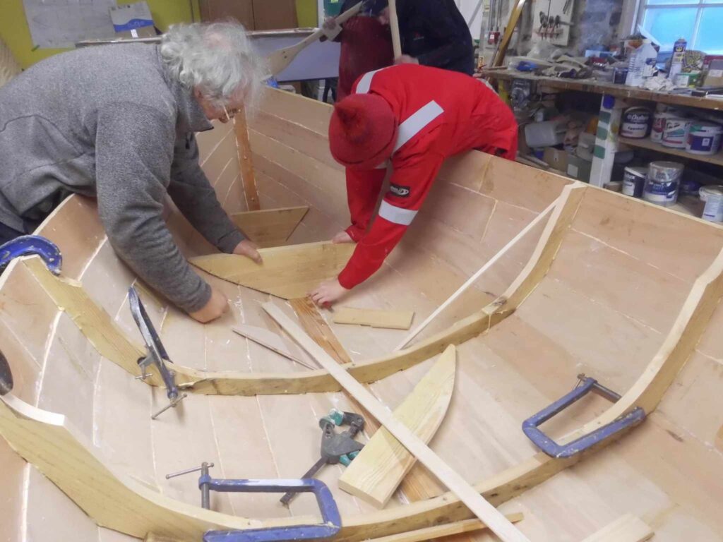 Image of Banff Academy pupils in the boat building workshop at Cullen Sea School