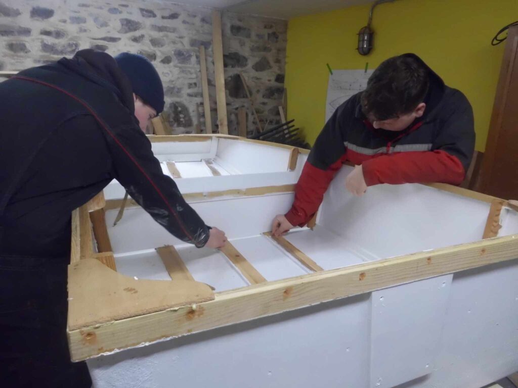 Image of Banff Academy pupils in the boat building workshop at Cullen Sea School