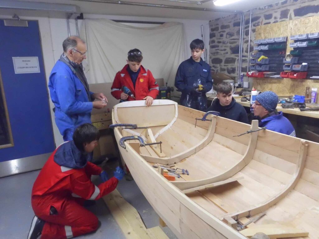Image of Banff Academy pupils in the boat building workshop at Cullen Sea School