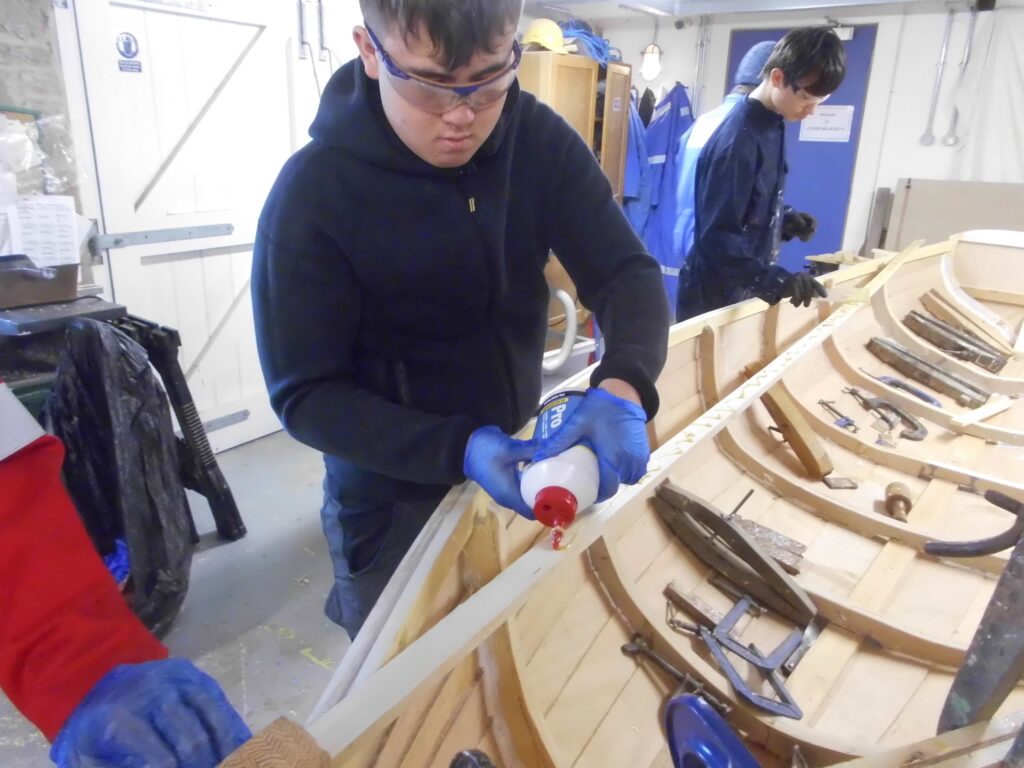 Image of Banff Academy pupils boat building in the sea school workshop