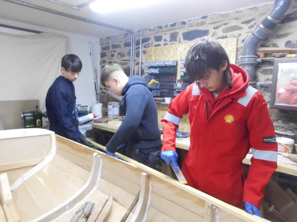 Image of Banff Academy pupils boat building in the sea school workshop