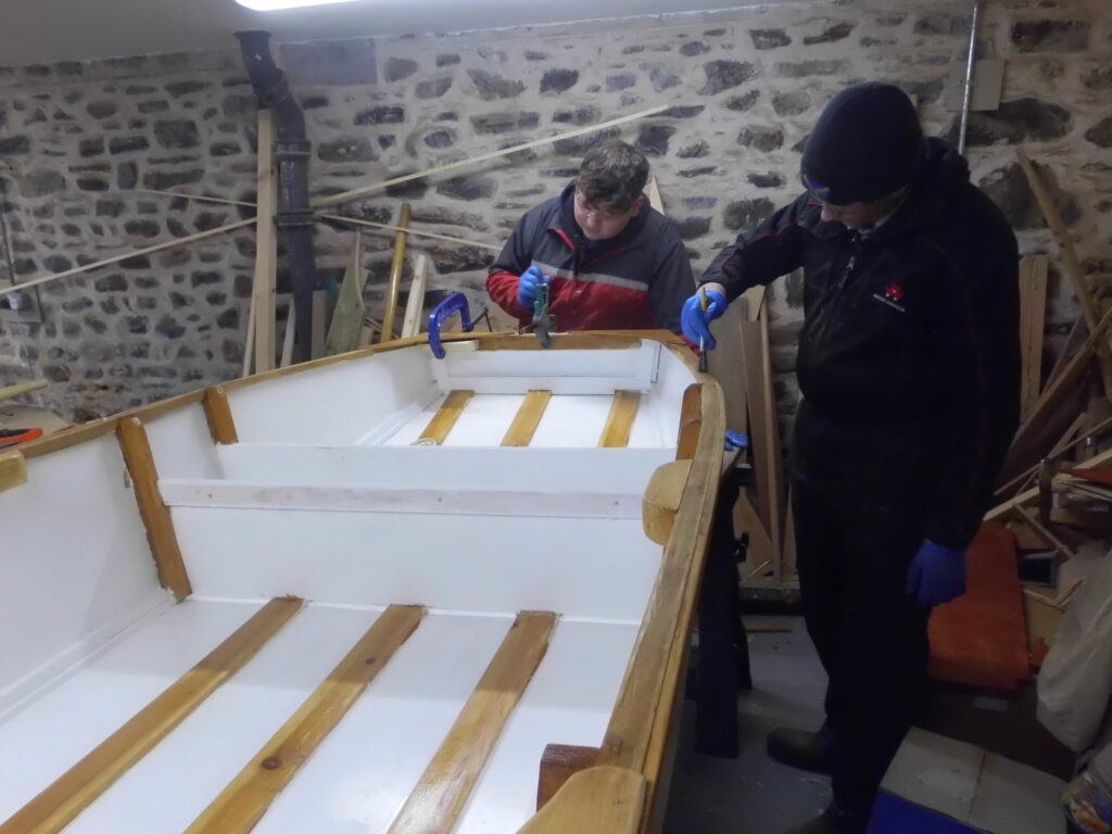 Image of Banff Academy pupils boat building in the sea school workshop