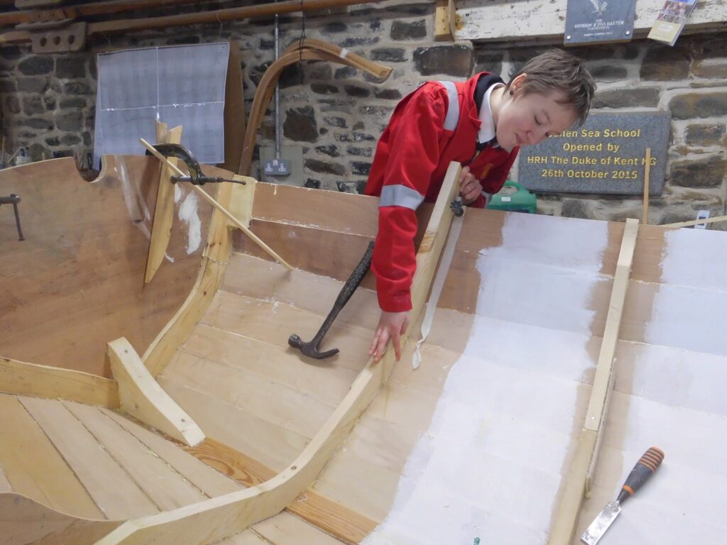 Image of Banff Academy pupils boat building in the sea school workshop