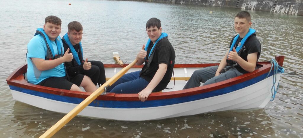 Image of Banff Academy students in boats built by them.