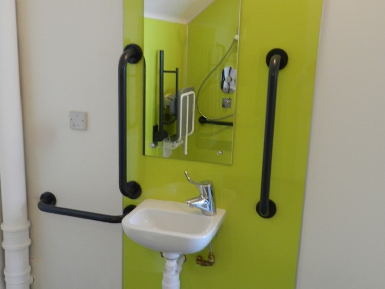 Image showing grab rail and sink in accessible changing room.