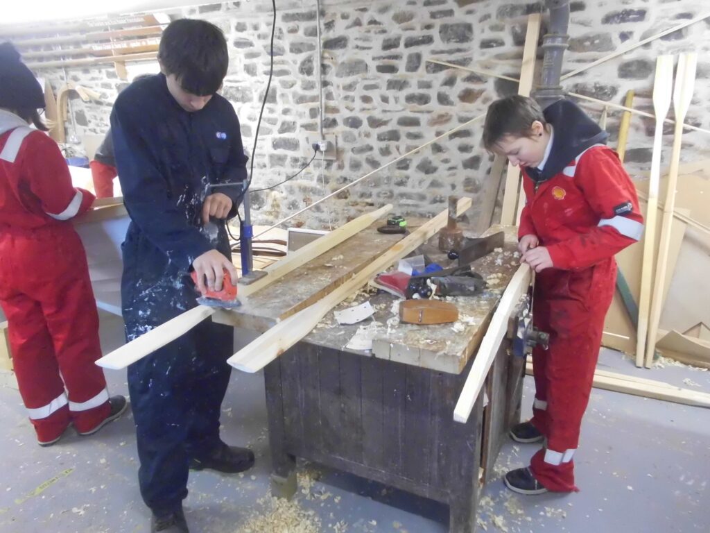 Image of Banff Academy pupils boat building in the workshop at Cullen Sea School