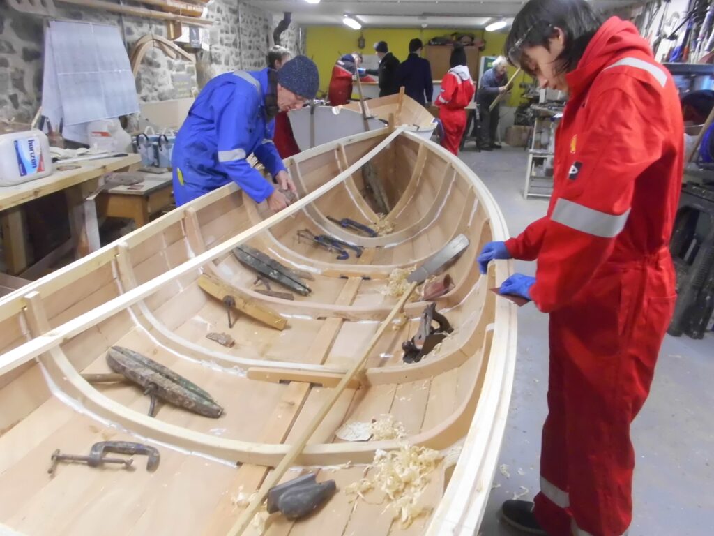 Image of Banff Academy pupils boat building in the workshop at Cullen Sea School