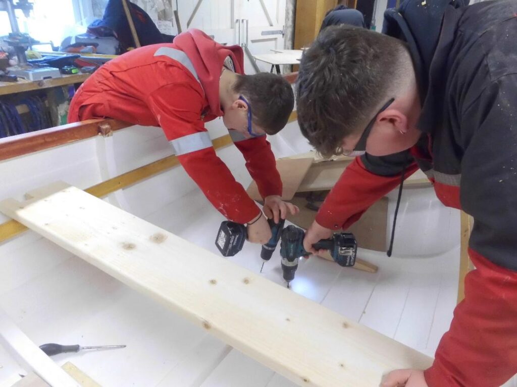 Image of two Banff Academy Students in the sea school workshop