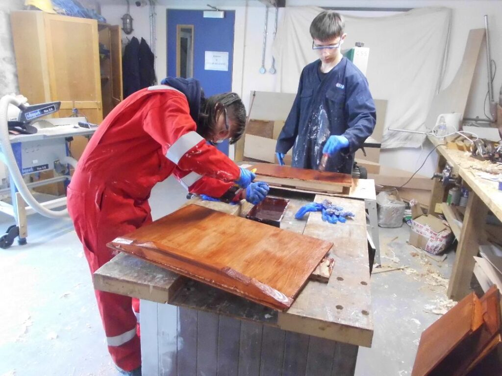 Image of two Banff Academy Students in the sea school workshop