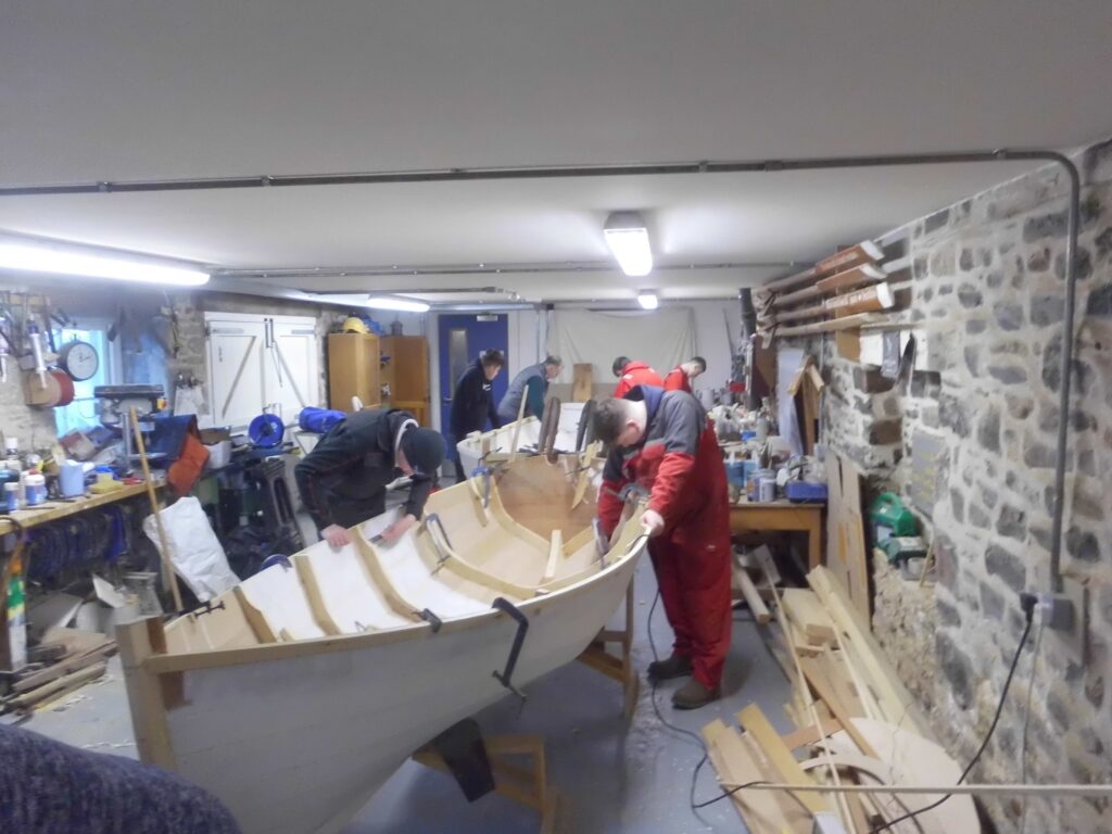 Image of Banff Academy pupils boat building in the workshop at Cullen Sea School