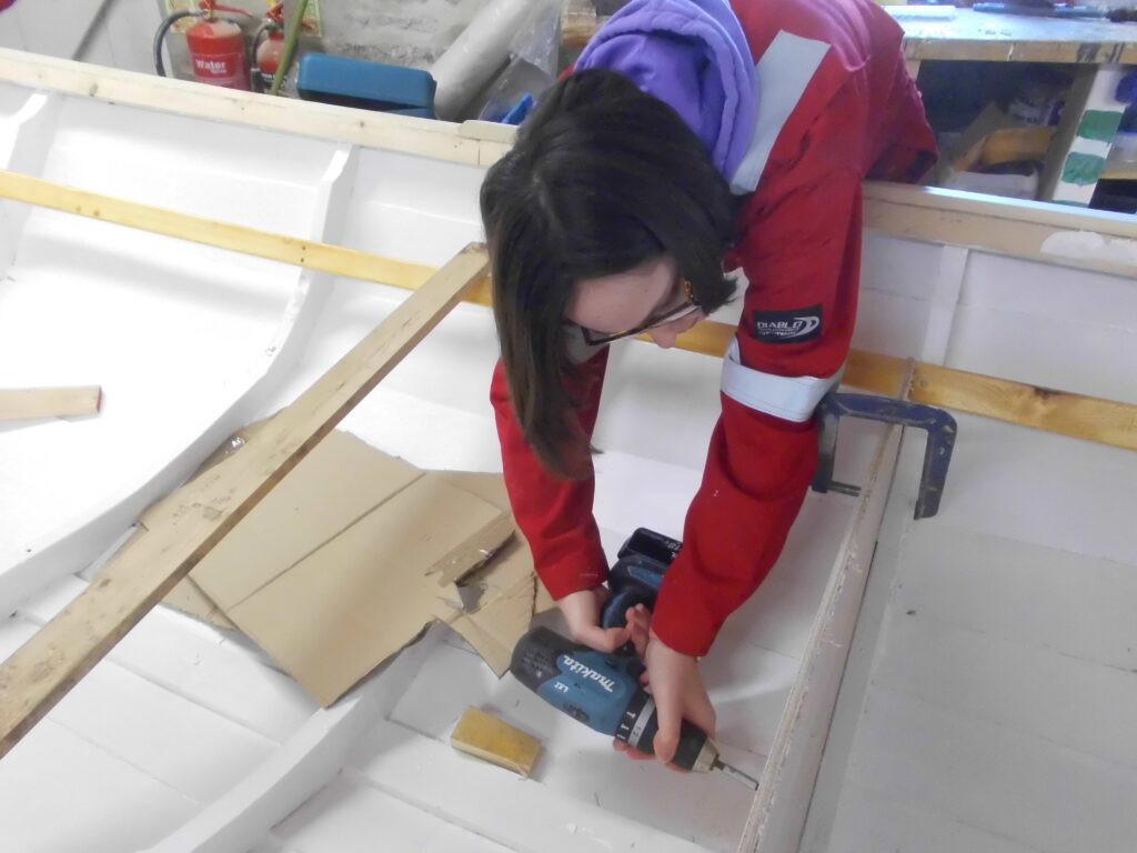 Image showing a Banff Academy pupil boat building in the sea school workshop