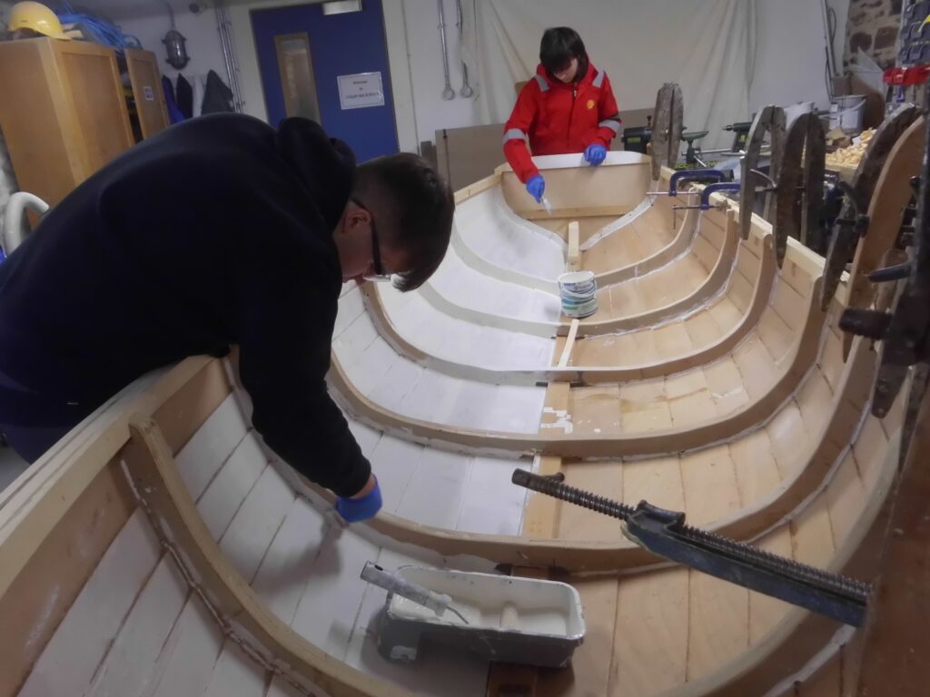 Image of Banff Academy pupils boat building in the workshop at Cullen Sea School