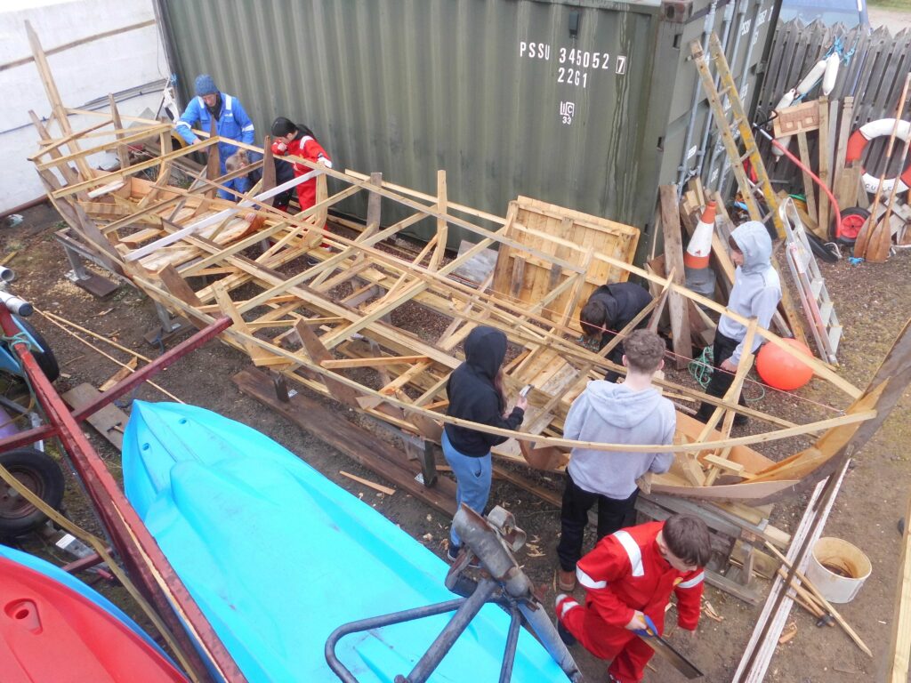 S2 Banff Academy Pupils at Cullen Sea School building a 
 Drakkar Viking Boat Replica 